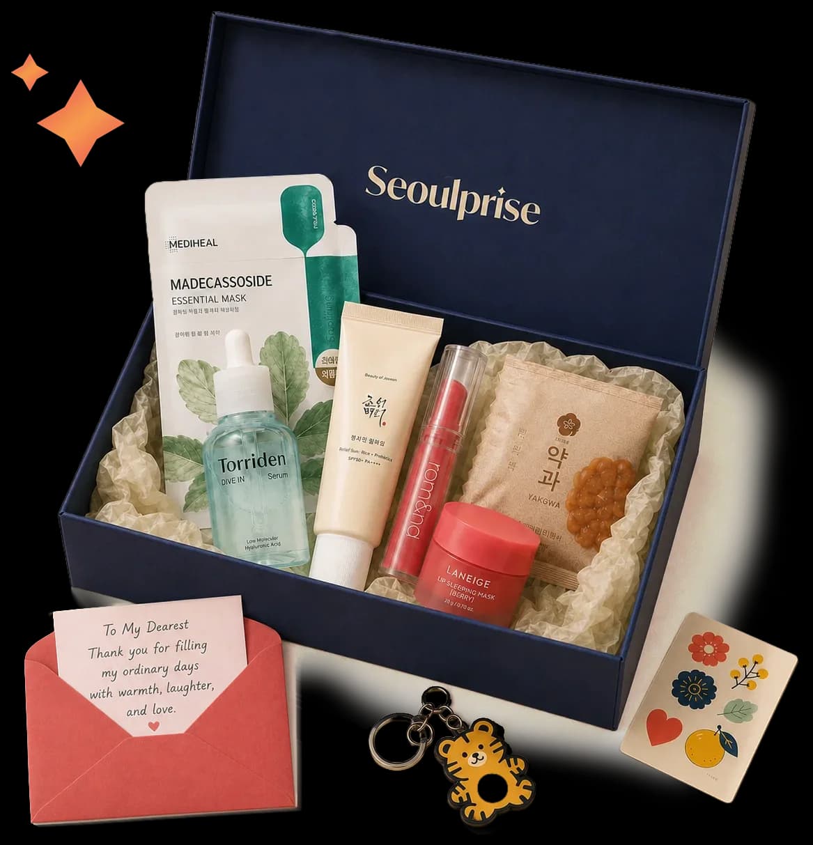An open SeoulPrise gift box with beauty, stationery, and snack treats